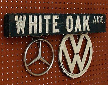 The sort of 'roadside collectibles' kids bring home: Car and truck emblems, and an old street sign from White Oak Avenue in the west San Fernando Valley. From 'Garage/Utility Collectibles' at the web's largest private collection of antiques & collectibles: https://www.ericwrobbel.com/collections/garage.htm