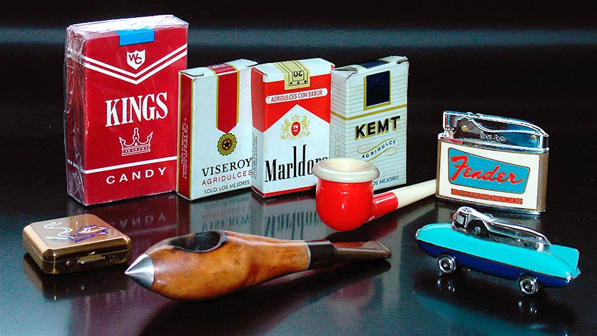 Candy cigarettes: Kings (US, c.1960s, I think),'Viseroy,' 'Marldoro,' & 'Kemt' are 21st century items from Mexico. Pocket ash tray, mid-century modern jet-age pipe, '50s bubble pipe, and two vintage cigarette lighters from Japan: 'Thunderbird' and a Nesor-Rosen for Fender Guitars ('Fine Electric Instruments'). From 'More Cigarettes and Smoking' at the web's largest private collection of antiques & collectibles: https://www.ericwrobbel.com/collections/cigarettes-and-smoking.htm
