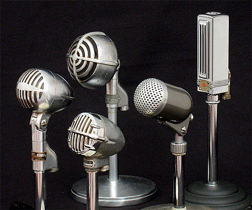 Antique Collectible Microphones: Shure 705A 'Ultra Wide Range Crystal' microphone (USA), next (in front) is the Astatic JT-30 (USA), and behind it a Shure crystal microphone, the 730B, followed by the Neat TM-3 dynamic mike from Onkyo Denki (Japan), and last is the Universal '5MM Velocity' microphone (USA). From 'Microphones' at the web's largest private collection of antiques & collectibles: https://www.ericwrobbel.com/collections/microphones.htm