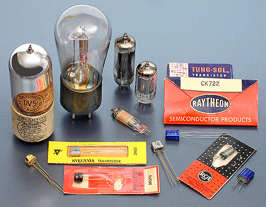 Vintage tubes and transistors: DeForest Audion tubes DV5 c.1920 and model 427 c.1930, and a couple of smaller 'peanut' tubes from the 1950s. The transistors here are all from the mid-to-late '50s, by Tung-Sol, Raytheon, Texas Instruments, Sylvania, Philco, and RCA. The small flat tube in the middle is a 'subminiature tube,' designed by Raytheon for the military. From the web's largest private collection of antiques & collectibles: https://www.ericwrobbel.com/collections/tubes-transistors.htm